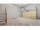 Spacious garage with an overhead door, concrete floor, and access to stairs at 1859 Mapmaker Dr, Dacula, GA 30019