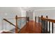 Hallway featuring hardwood floors and decorative wood railing at 1859 Mapmaker Dr, Dacula, GA 30019