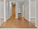 Bright hallway featuring wood-look flooring, stairs, and doorways leading to various rooms at 1859 Mapmaker Dr, Dacula, GA 30019