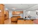 Kitchen with wooden cabinetry, granite countertops, and hardwood flooring at 1859 Mapmaker Dr, Dacula, GA 30019