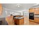 Open kitchen featuring an island, modern appliances, and an eat-in area for casual dining at 1859 Mapmaker Dr, Dacula, GA 30019
