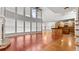 Living room with large windows, hardwood floors, and an open floor plan leading into the kitchen at 1859 Mapmaker Dr, Dacula, GA 30019