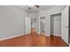 Main bedroom with ceiling fan, hardwood floors, neutral walls, and ensuite bathroom with walk-in closet at 1859 Mapmaker Dr, Dacula, GA 30019