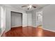 The spacious primary bedroom boasts wood floors, a ceiling fan, a closet, and an ensuite bath at 1859 Mapmaker Dr, Dacula, GA 30019