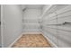 Pantry featuring wire shelving and tile flooring at 1859 Mapmaker Dr, Dacula, GA 30019