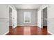 Bright walk-in closet with hardwood floors, access to closet storage solutions, and natural light from a window at 1859 Mapmaker Dr, Dacula, GA 30019