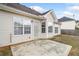 Back of a home with large windows and a concrete patio at 4477 James Wade Dr, Snellville, GA 30039