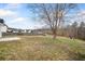 Large backyard with a mature tree, grass and a privacy fence at 4477 James Wade Dr, Snellville, GA 30039