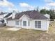 Back view of a house with an open patio and well-manicured backyard lawn at 4477 James Wade Dr, Snellville, GA 30039