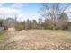A large grass and dirt backyard with a privacy fence at 4477 James Wade Dr, Snellville, GA 30039