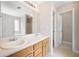 Bright bathroom with a double sink vanity and large mirror at 4477 James Wade Dr, Snellville, GA 30039