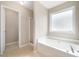 Bathroom featuring a garden tub and a walk-in shower at 4477 James Wade Dr, Snellville, GA 30039