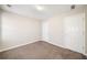 A bedroom with neutral colored walls and carpet with two doors at 4477 James Wade Dr, Snellville, GA 30039