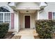 Inviting home entrance featuring a classic door and well-manicured greenery at 4477 James Wade Dr, Snellville, GA 30039