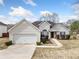Well-maintained single-Gathering home with a two-car garage and beautiful landscaping at 4477 James Wade Dr, Snellville, GA 30039