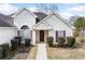 Charming home entrance with neat landscaping, offering inviting curb appeal at 4477 James Wade Dr, Snellville, GA 30039