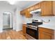 Kitchen featuring stainless steel range, wood cabinets and laminate countertops at 4477 James Wade Dr, Snellville, GA 30039