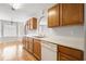Bright kitchen featuring wood cabinets, stainless steel sink, and white appliances at 4477 James Wade Dr, Snellville, GA 30039