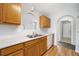 Bright kitchen featuring wood cabinets, stainless steel sink, and white appliances at 4477 James Wade Dr, Snellville, GA 30039