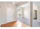 Bright living room featuring hardwood floors, large windows, and elegant light fixtures at 4477 James Wade Dr, Snellville, GA 30039