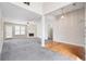 Spacious living room boasts fireplace, ceiling fan, and glass panel door leading to the yard at 4477 James Wade Dr, Snellville, GA 30039