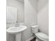 Bathroom features a pedestal sink, a toilet, and a modern gray paint at 1705 Trout Lily Pl, Smyrna, GA 30126