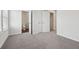 Carpeted bedroom shows closet and bathroom entrances, and a window with blinds at 1705 Trout Lily Pl, Smyrna, GA 30126