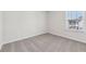 Carpeted bedroom features a window with blinds and neutral walls at 1705 Trout Lily Pl, Smyrna, GA 30126