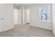 Carpeted bedroom features a window with blinds and a closet at 1705 Trout Lily Pl, Smyrna, GA 30126