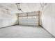 Empty two car garage with concrete flooring and a white door ready for customization at 1705 Trout Lily Pl, Smyrna, GA 30126