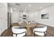 Staged kitchen and dining area, featuring stainless steel appliances and hardwood floors at 1705 Trout Lily Pl, Smyrna, GA 30126