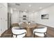 Staged kitchen and dining area, featuring stainless steel appliances and hardwood floors at 1705 Trout Lily Pl, Smyrna, GA 30126