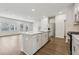 Open-concept kitchen with a large island, stainless steel appliances, and hardwood floors at 1705 Trout Lily Pl, Smyrna, GA 30126