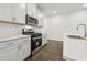 Modern kitchen features stainless steel appliances, gray cabinets, and a tile backsplash at 1705 Trout Lily Pl, Smyrna, GA 30126