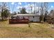 Expansive backyard featuring a large deck, play set, and ample space for outdoor activities at 3521 Stone Ridge Dr, Douglasville, GA 30134