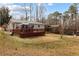 Sprawling yard with a house, gazebo, deck, play area, and mature trees at 3521 Stone Ridge Dr, Douglasville, GA 30134
