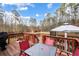 Deck with furniture and a gazebo overlooking a spacious grassy yard and wooded area at 3521 Stone Ridge Dr, Douglasville, GA 30134