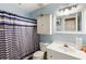 Blue bathroom featuring a shower-tub, vanity, and storage cabinet at 3521 Stone Ridge Dr, Douglasville, GA 30134