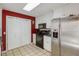 The kitchen features a stainless steel refrigerator, bright lighting, and white cabinets at 3521 Stone Ridge Dr, Douglasville, GA 30134