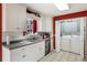 Kitchen featuring white cabinets, a stainless steel dishwasher, and a view of the laundry at 3521 Stone Ridge Dr, Douglasville, GA 30134