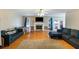 Spacious living room with a fireplace, two sofas, and hardwood floors at 3521 Stone Ridge Dr, Douglasville, GA 30134