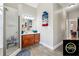 Bright primary bathroom featuring a glass shower, a wooden vanity, and wood-look tile floors at 429 Telluride Ct, Locust Grove, GA 30248