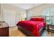 Bedroom featuring a king size bed, wood-look flooring, and a closet at 429 Telluride Ct, Locust Grove, GA 30248