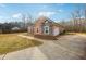 Spacious driveway and side view of a home with stone accents and a well-maintained yard at 429 Telluride Ct, Locust Grove, GA 30248