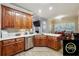 A well-designed kitchen with stone countertops, wood cabinets and stainless steel appliances at 429 Telluride Ct, Locust Grove, GA 30248