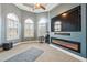 Cozy living room featuring a modern fireplace, large TV, and stylish window shutters at 429 Telluride Ct, Locust Grove, GA 30248