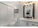Clean bathroom featuring a shower with white curtain and tile, and a sink with white cabinets at 125 Warren Ne St, Atlanta, GA 30317