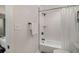 Bright bathroom featuring a shower with white tile and curtain, and dark bronze hardware at 125 Warren Ne St, Atlanta, GA 30317
