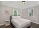 Bright bedroom features hardwood floors, a queen bed, neutral walls, and two windows offering natural light at 125 Warren Ne St, Atlanta, GA 30317