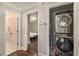 Hallway with access to the bedroom, bathroom, and a closet with a stacked washer and dryer at 125 Warren Ne St, Atlanta, GA 30317